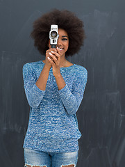 Image showing african american woman using a retro video camera