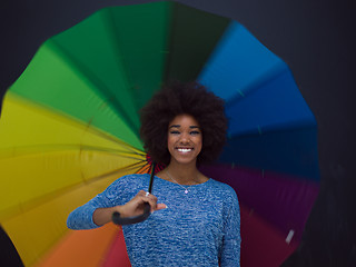 Image showing african american woman holding a colorful umbrella