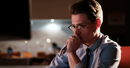 Image showing man working on computer in dark office