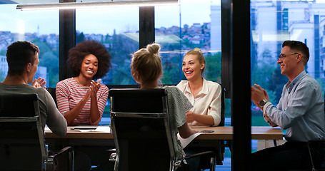 Image showing Multiethnic startup business team in night office