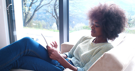 Image showing african american woman at home using digital tablet