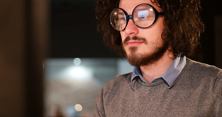 Image showing man working on computer in dark office