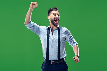 Image showing Winning success man happy ecstatic celebrating being a winner. Dynamic energetic image of male model