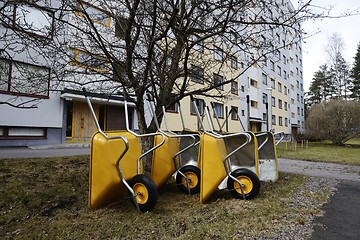 Image showing lot of empty new garden wheelbarrows in the yard