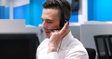 Image showing male call centre operator doing his job