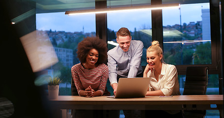 Image showing Multiethnic startup business team in night office