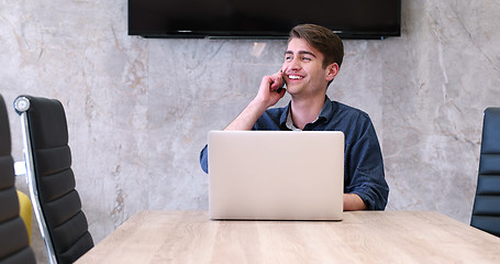 Image showing businessman working using a laptop in startup office