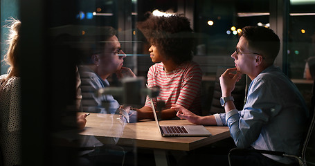 Image showing Multiethnic startup business team in night office