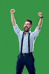 Image showing Winning success man happy ecstatic celebrating being a winner. Dynamic energetic image of male model