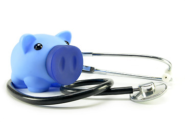 Image showing Stethoscope and piggy bank