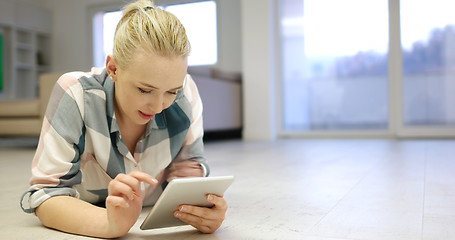 Image showing young women using tablet computer on the floor