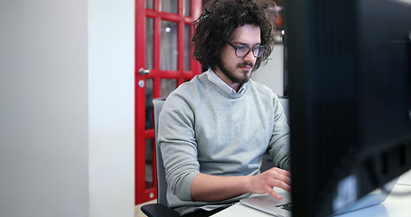 Image showing businessman working using a laptop in startup office