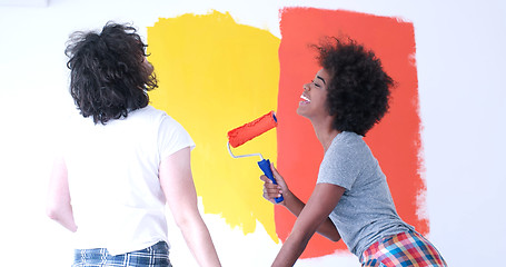 Image showing multiethnic couple painting interior wall