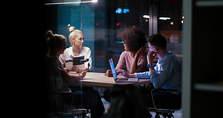 Image showing Multiethnic startup business team in night office