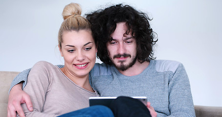 Image showing couple relaxing at  home with tablet computers