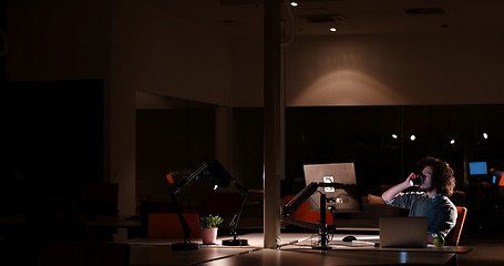 Image showing man working on computer in dark office