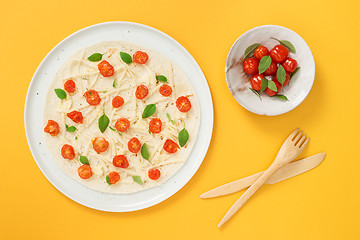 Image showing Vegetarian tortilla and tomatoes on yellow background