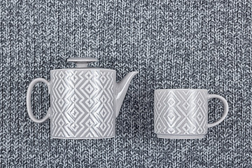 Image showing Ceramic teapot and cup on gray wool background