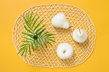 Image showing Palm leaves in a vase and white decorative fruits