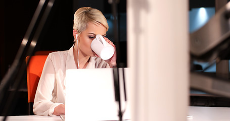 Image showing woman working on laptop in night office