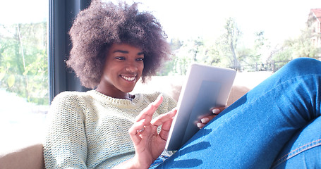 Image showing african american woman at home using digital tablet