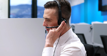 Image showing male call centre operator doing his job