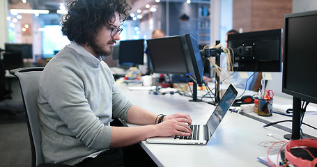 Image showing businessman working using a laptop in startup office