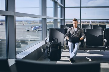 Image showing Traveler using laptop in airport terminal