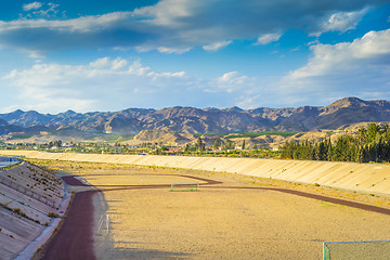 Image showing A football field on the mountain s on tha background.