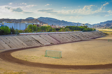 Image showing A football field on the mountain s on tha background.