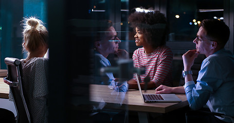 Image showing Multiethnic startup business team in night office