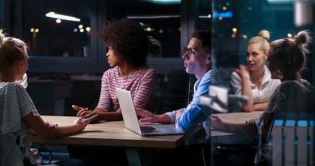 Image showing Multiethnic startup business team in night office