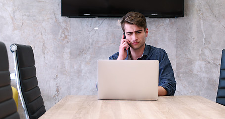 Image showing businessman working using a laptop in startup office