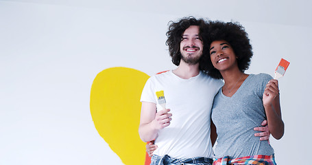 Image showing couple with painted heart on wall