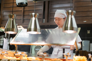 Image showing Japanese Ramen chefs prepare a bowl of traditional home made ramen noodle for customers in Kyoto, Japan.