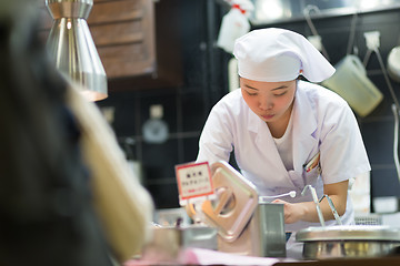 Image showing Japanese Ramen chefs prepare a bowl of traditional home made ramen noodle for customers in Kyoto, Japan.