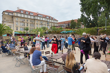 Image showing People dancing salsa outdoors at city square on one of many summer events in Berlin, Germany on 28th of september, 2016.