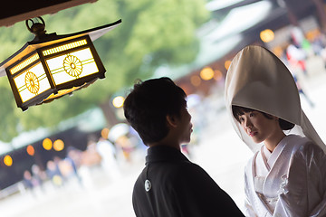 Image showing Young happy groom and bride during japanese traditional wedding ceremony at Meiji-jingu shrine in Tokyo, Japan on November 23, 2013.