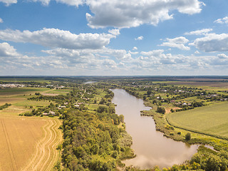 Image showing Panoramic view with farmfields, countries, wide river on a background blue cloudy sky in a summer day.