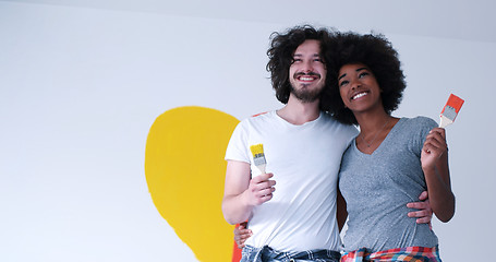 Image showing couple with painted heart on wall