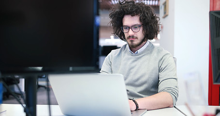 Image showing businessman working using a laptop in startup office