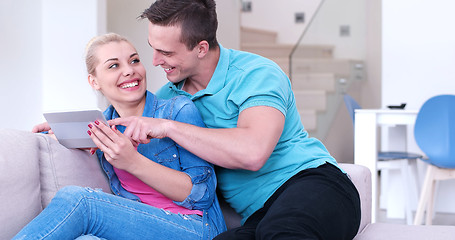 Image showing couple relaxing at  home with tablet computers