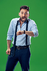 Image showing Handsome businessman checking his wrist-watch Isolated on white background