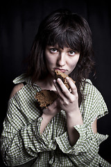 Image showing Poor beggar woman with a piece of bread.