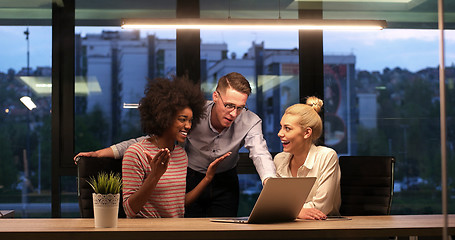 Image showing Multiethnic startup business team in night office