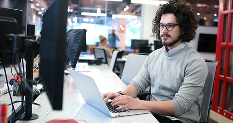 Image showing businessman working using a laptop in startup office