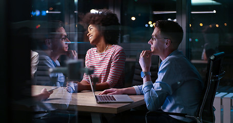 Image showing Multiethnic startup business team in night office