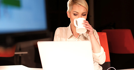 Image showing woman working on laptop in night office