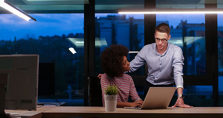 Image showing Multiethnic startup business team in night office