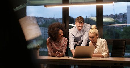 Image showing Multiethnic startup business team in night office